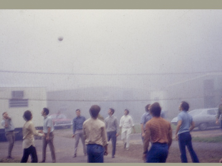 Students in the UConn School of Medicine taking a break from classes and playing volleyball in the parking lot in front of temporary metal buildings that served the school before UConn Health was built.