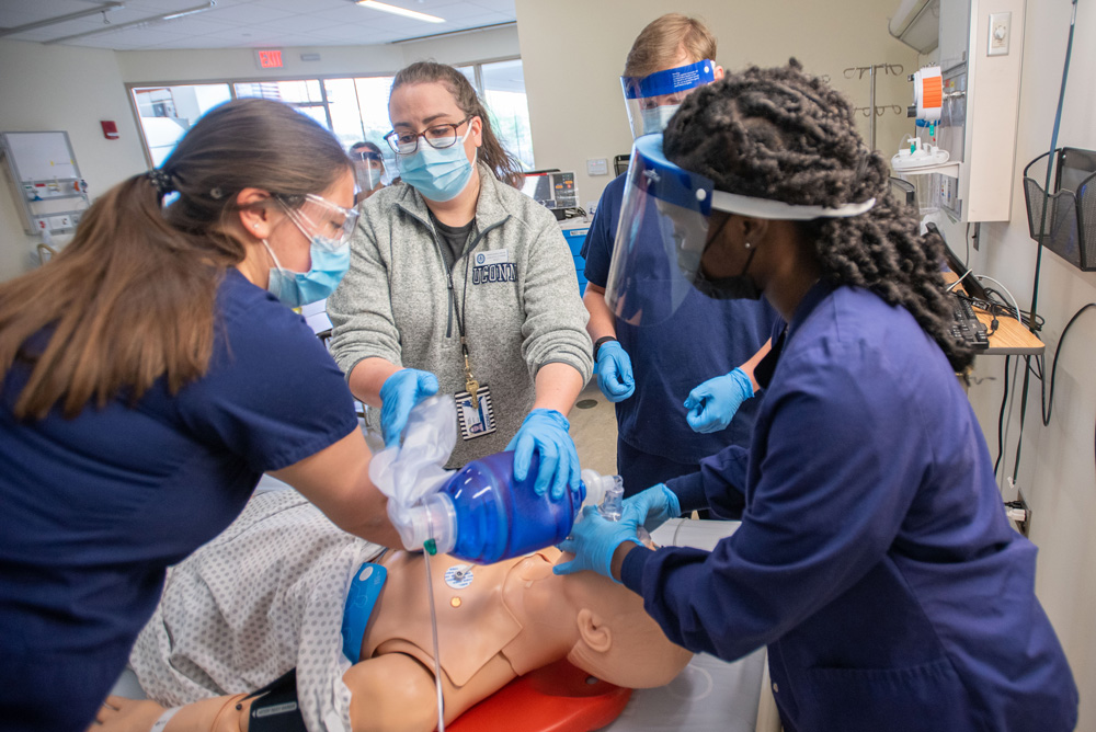 Students receiving instruction on performing CPR in a School of Nursing Simulation Lab