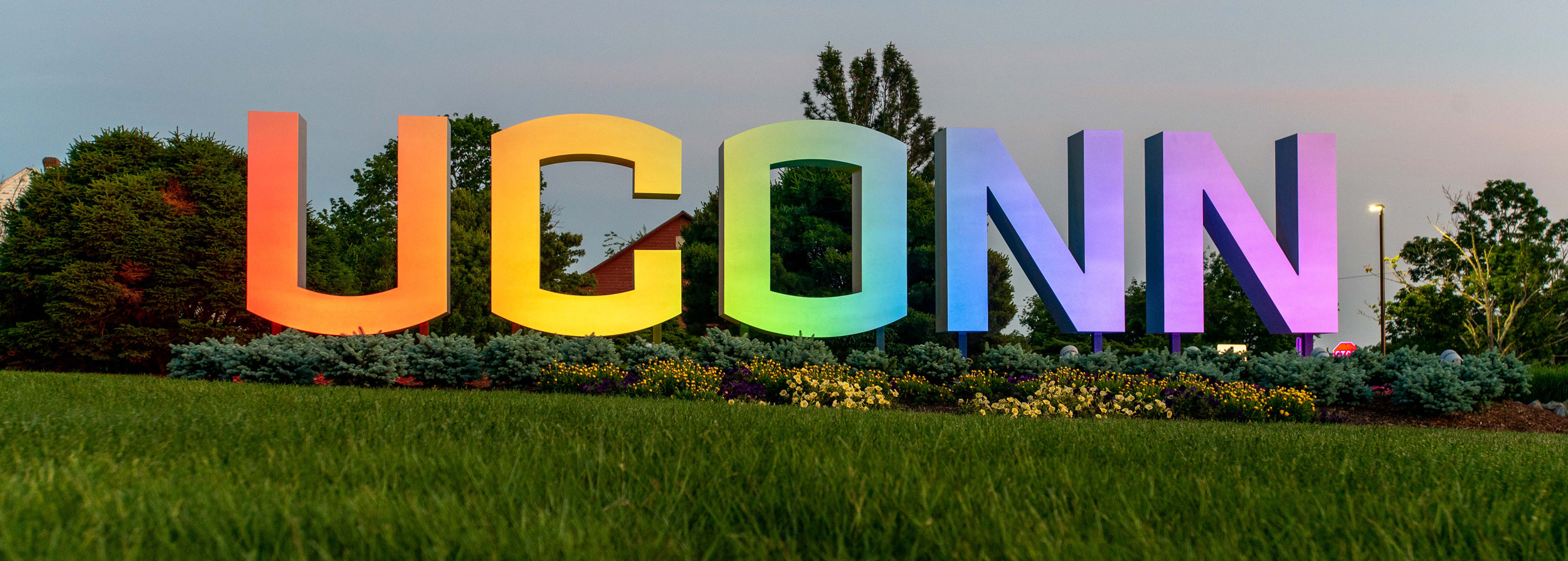 he UConn sign lit up at night to support LGBTQIA2+ pride