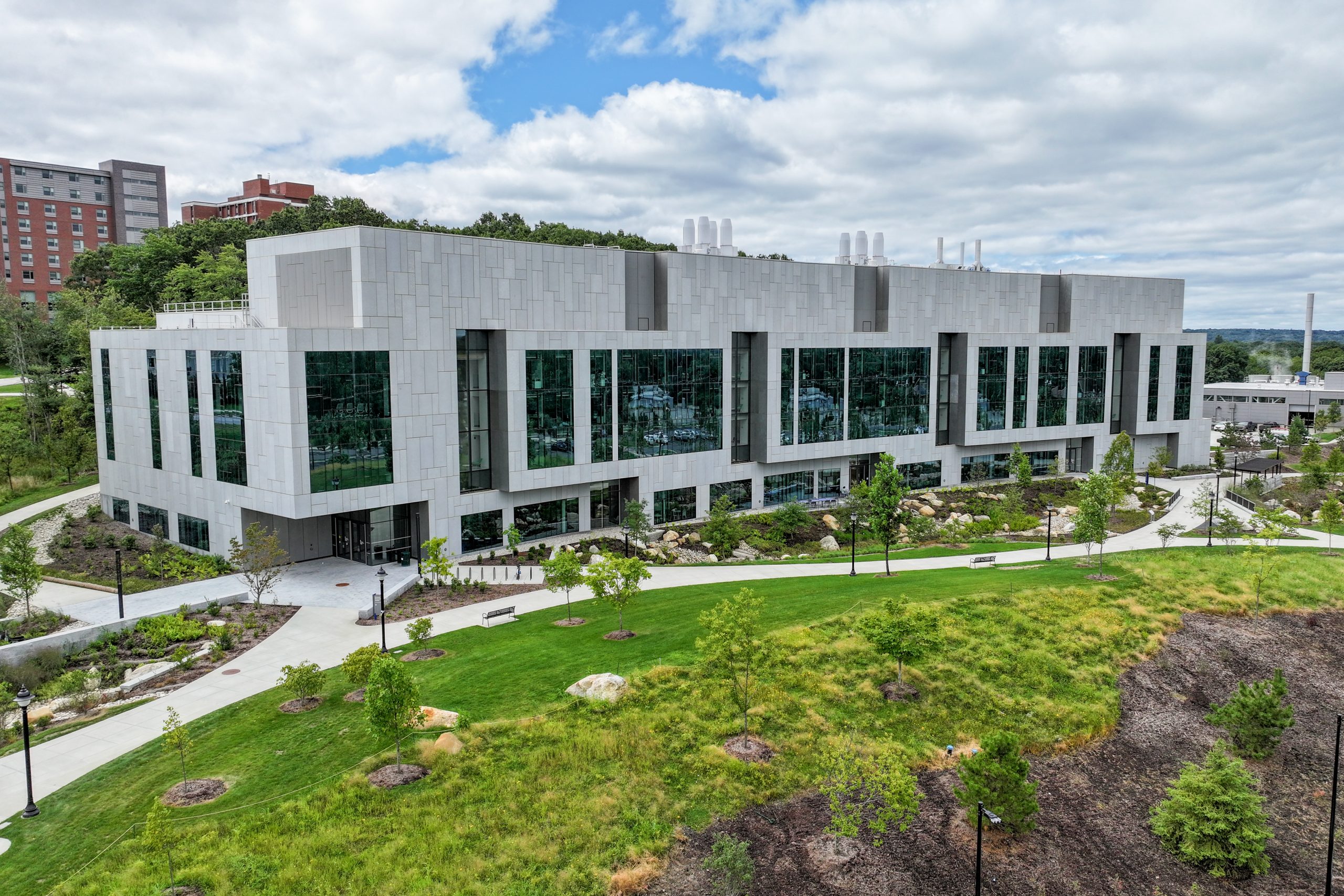 2024-08-20_StorrsCampusSummerII-39.jpg Exterior image of UConn's Science One building with cloudy skies and green grass.