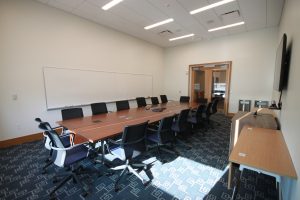 A long wooden conference table with chairs.