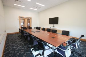 A long wooden conference table with chairs.