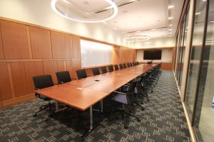 A long wooden table with chairs.