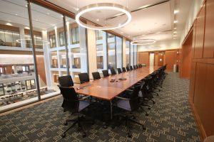 A long wooden table with chairs.