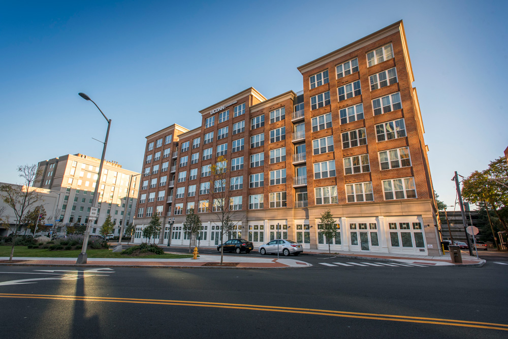 Exterior view of the Stamford Residence Hall (Dorm) at dusk and night