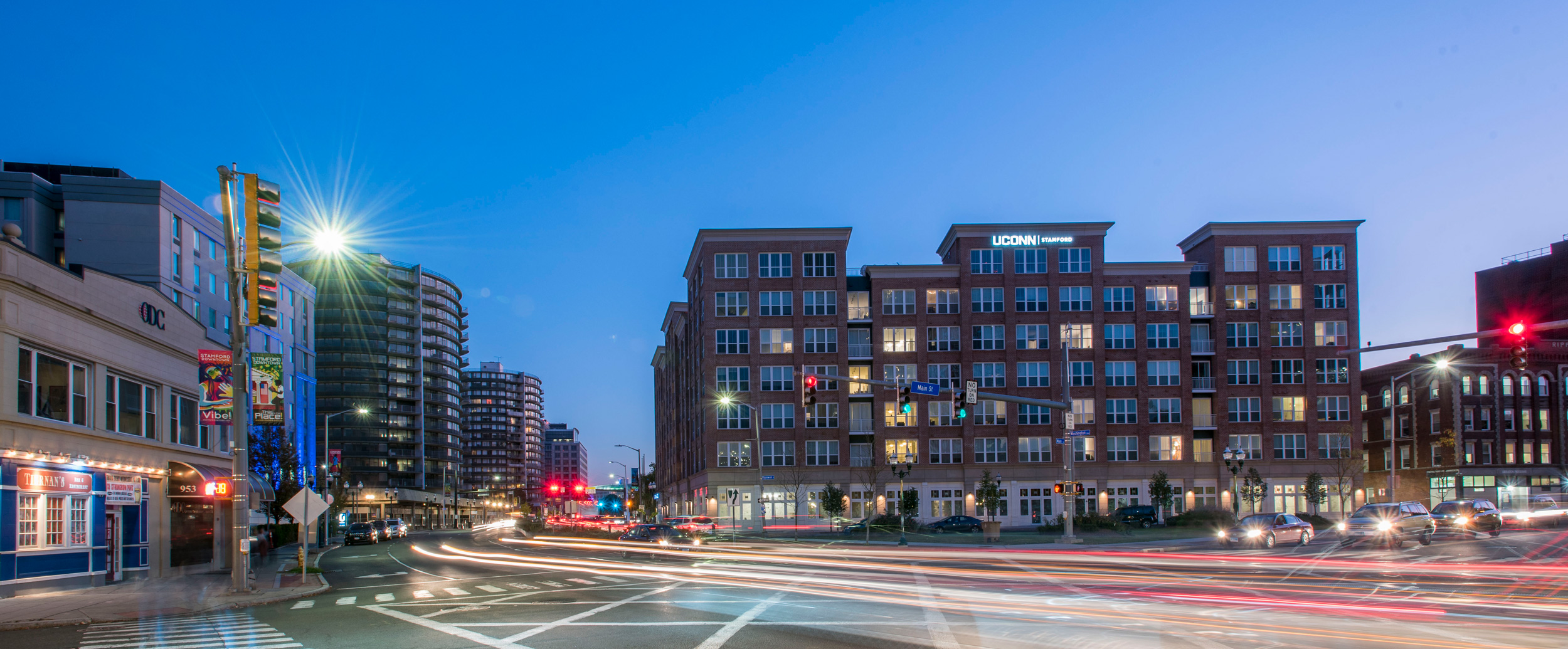 Exterior view of the Stamford Residence Hall (Dorm) at dusk and night