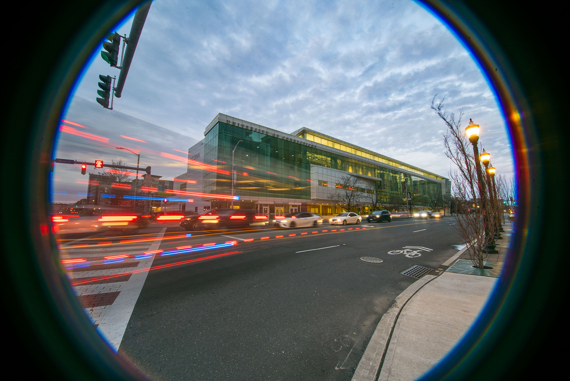 Exterior view of UConn Stamford at dusk with a light trail from passing vehicles