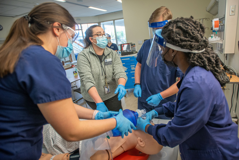 Students receiving instruction on performing CPR in a School of Nursing Simulation Lab