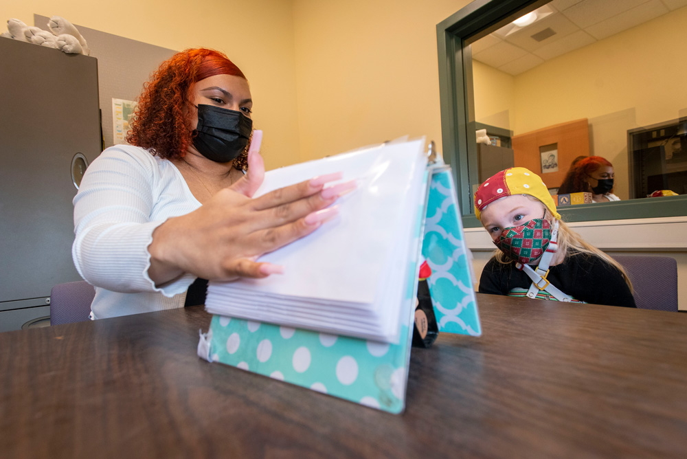 A student performing a memory experiment with a child at the Cognition, Action and Psychophysiology (C.A.P) at the UConn Waterbury campus.