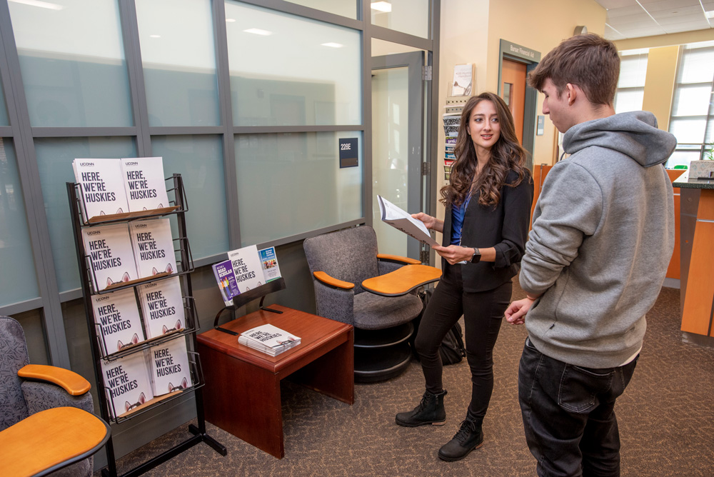 Admissions counselor talking to a student at the Waterbury Campus.