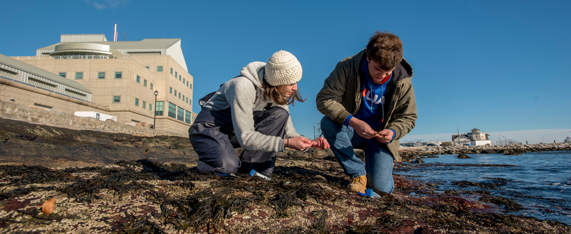 faculty member and student doing research on the coast