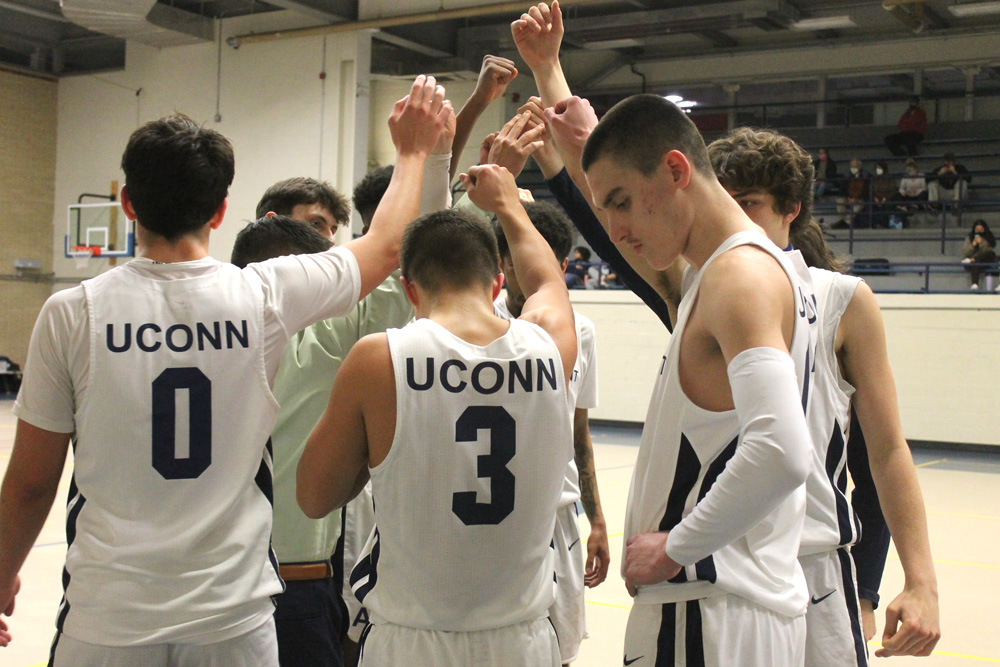 UConn Avery Point Mens Basketball team in a huddle