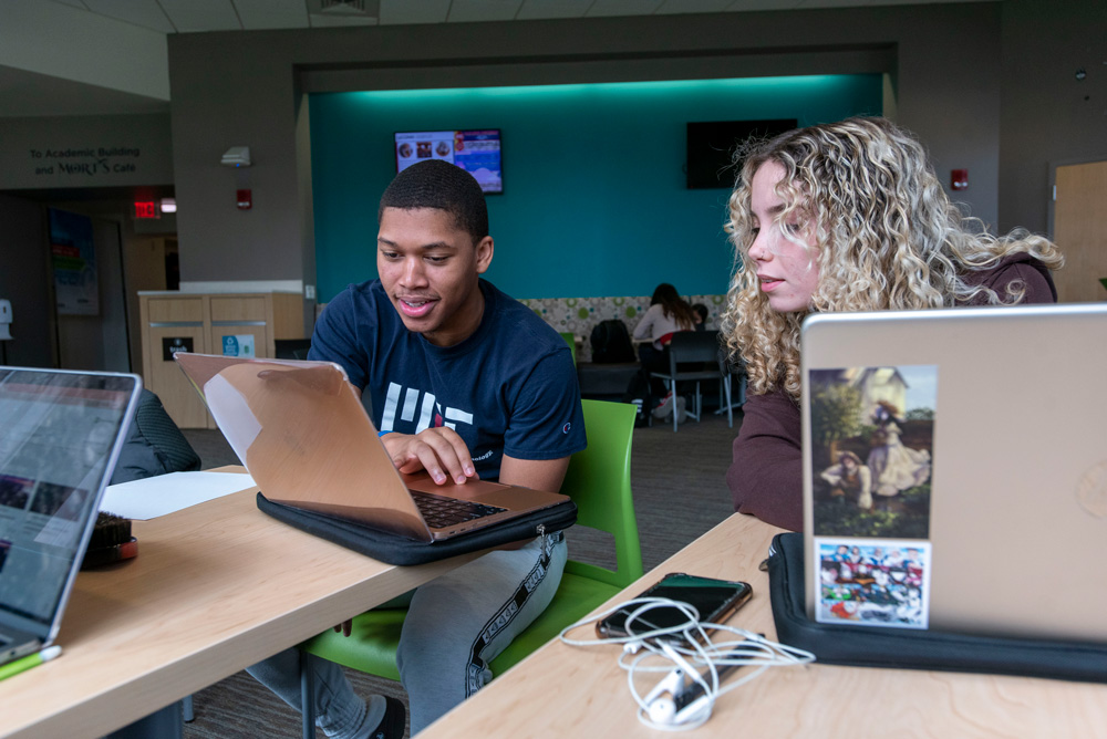 Students socializing, talking, in the lounge at the UConn Avery Point campus